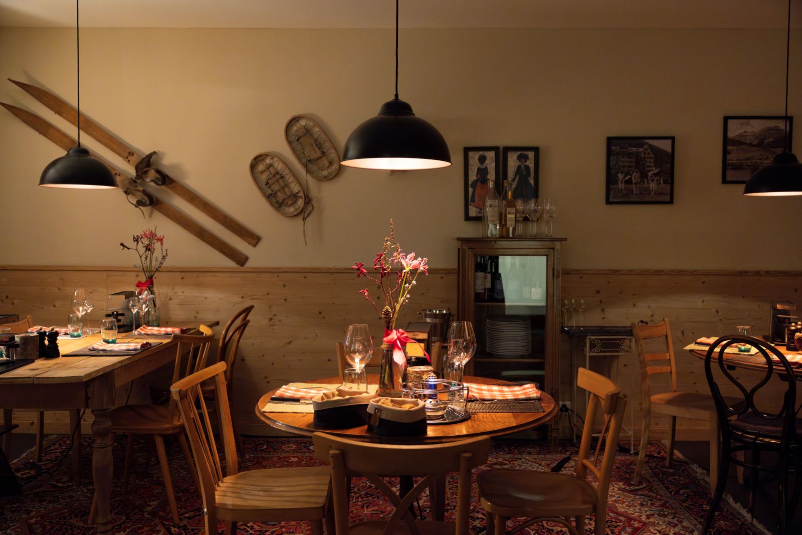 Hotel Cresta Palace, St Moritz - rustic restaurant with Alpine themed pictures and objects on the wall